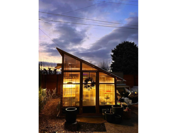 Slant-Roof Greenhouse Lit Up at Sunset