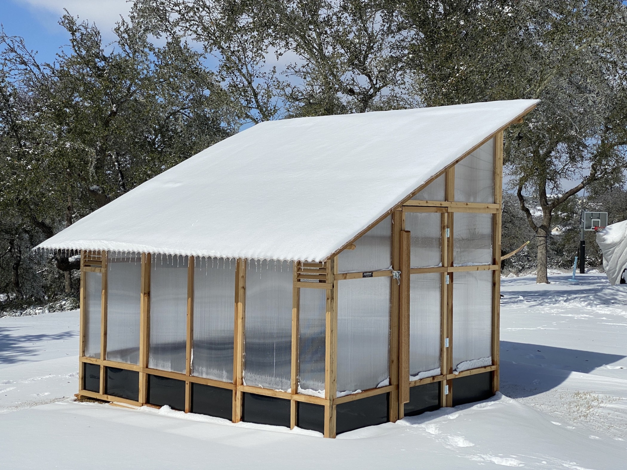 Roost and Root Cedar Slant-Roof Greenhouse with Snow
